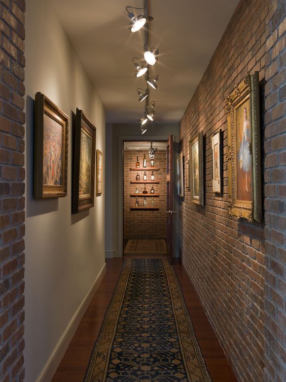 industrial hallway with artworks that are highlighted with track lights