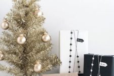 28 gold tabletop tree with gold ornaments and monochrome gifts