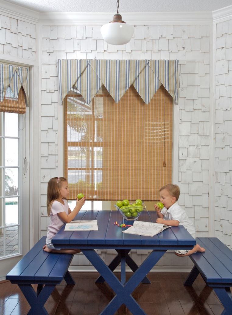 a seaside-inspired breakfast zone with a navy picnic table and benches