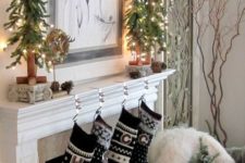 30 black and white stockings and lit up small trees on the mantel