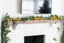 31 citrus and greenery garland to cover a mantel is a chic modern idea