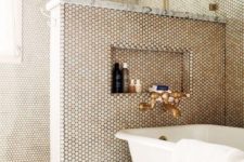 31 penny tiles cover the whole bathroom and shower, a half wall keeps the excessive water awya