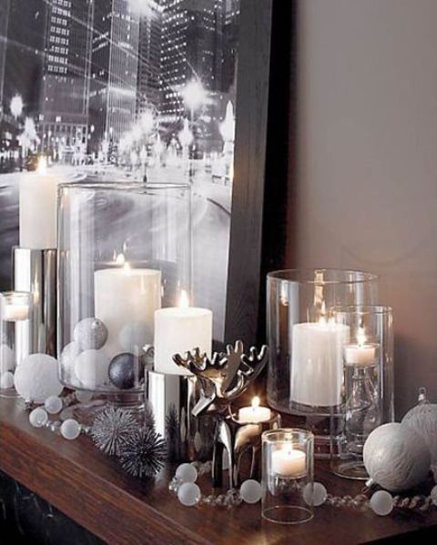 metallic and white mantel decor with large candles