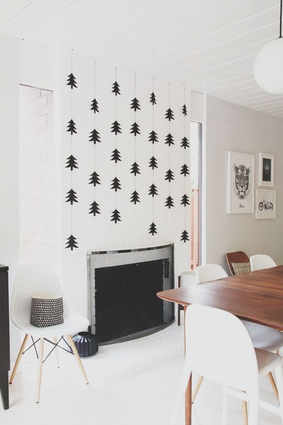statement fireplace wall with black trees over it