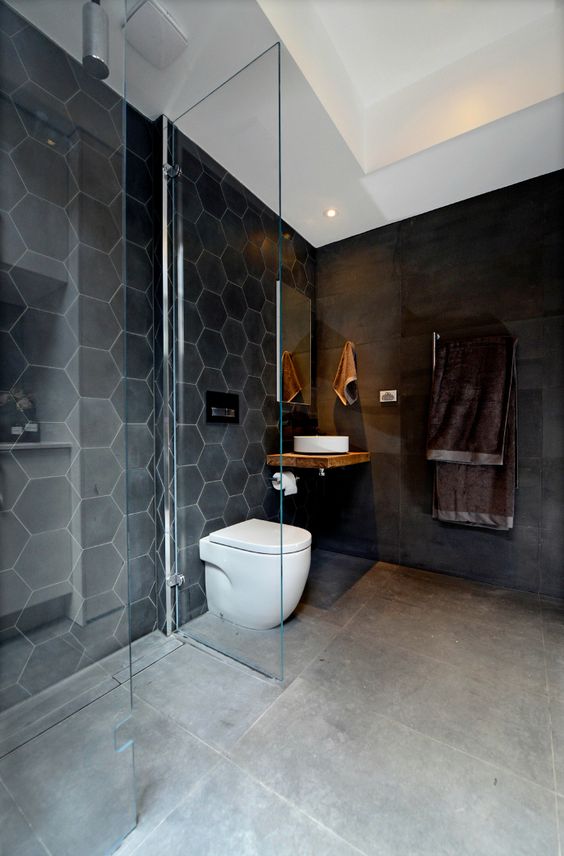 black hex tiles and a matte black wall for a minimalist look