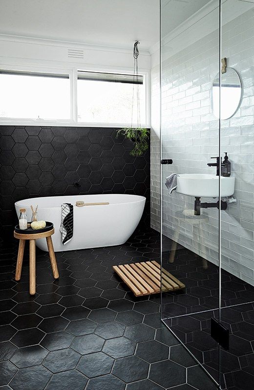 black hexagon tiles on the floors and walls for a masculine bathroom