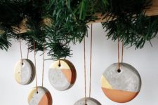 39 geometric concrete Christmas ornaments on a wooden beam