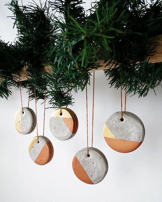 geometric concrete Christmas ornaments on a wooden beam