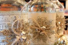 41 such bottles covered with music sheets, snowflakes and jingle bells can be DIYed and turned into vases