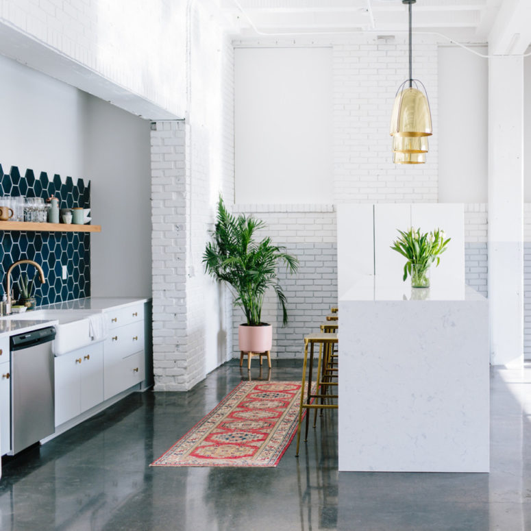 a navy hexagonal tile backlash is a highlight of this minimalist kitchen (Cambria)