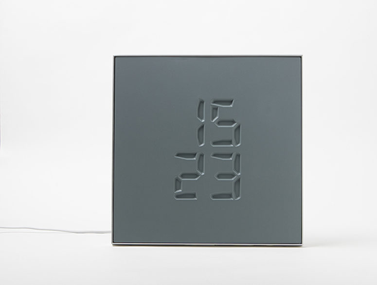 Etch clock engraves time on its surface