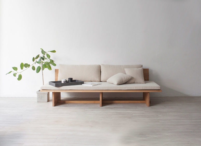The sofa is made of wood and soft cushions, which are removable if you want to clean them