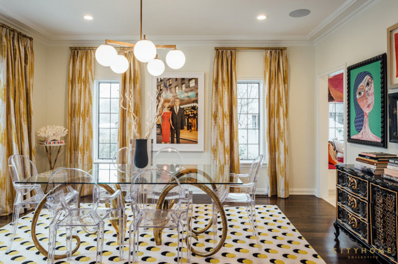 The dining space strikes with unique artworks and a horn-legged dining table with a glass top