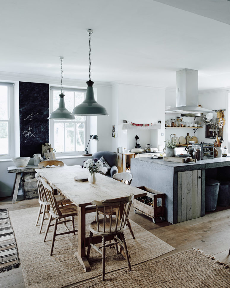The kitchen is filled with light, the working surfaces are metal and concrete, the furniture is wooden The kitchen is filled with light, the working surfaces are metal and concrete, the furniture is wooden