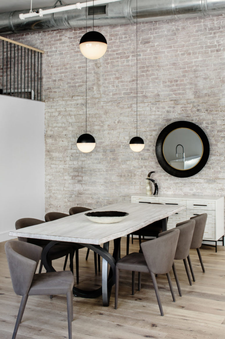 whitewashed accent wall The whole space features an amazing whitewashed brick wall, and there's a whitewashed wooden dining table that echoes