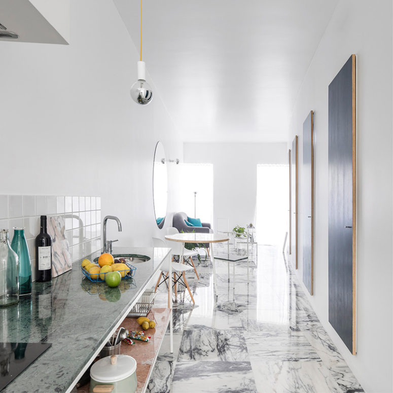 The kitchen is a simple open space wwith marble and stone surfaces as such a look is more airy