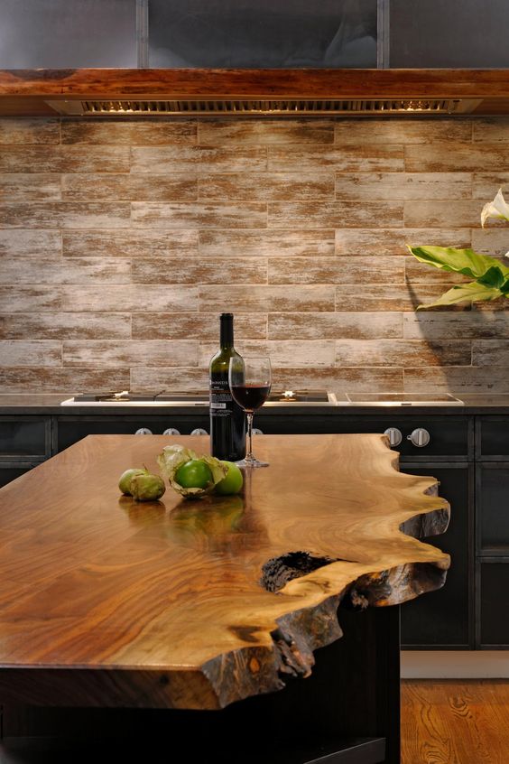 a beautiful raw wood edge kitchen island in an industrial kitchen makes a statement