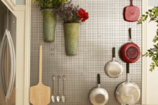 04 framed metal pegboard with hooks for utensils and metal pots attached