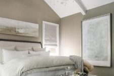 04 taupe and gray bedroom features a wall painted taupe lined with a gray and taupe abstract panorama art placed above a wood sleigh bed