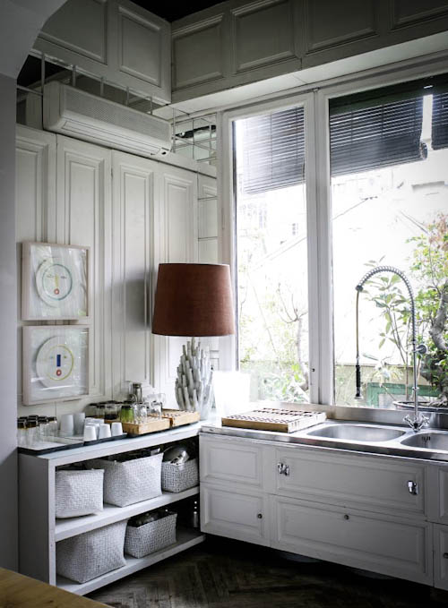 The kitchen is cozy and more modern, done in white