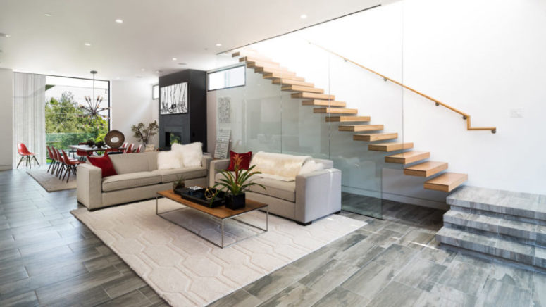 The floors are covered with grey and beige tiles, and the staircase is exciting, of wood and glass, looks very modern The floors are covered with grey and beige tiles, and the staircase is exciting, of wood and glass, looks very modern