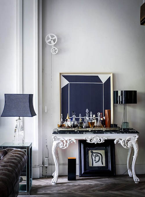 The living room features an open home bar on a refined table