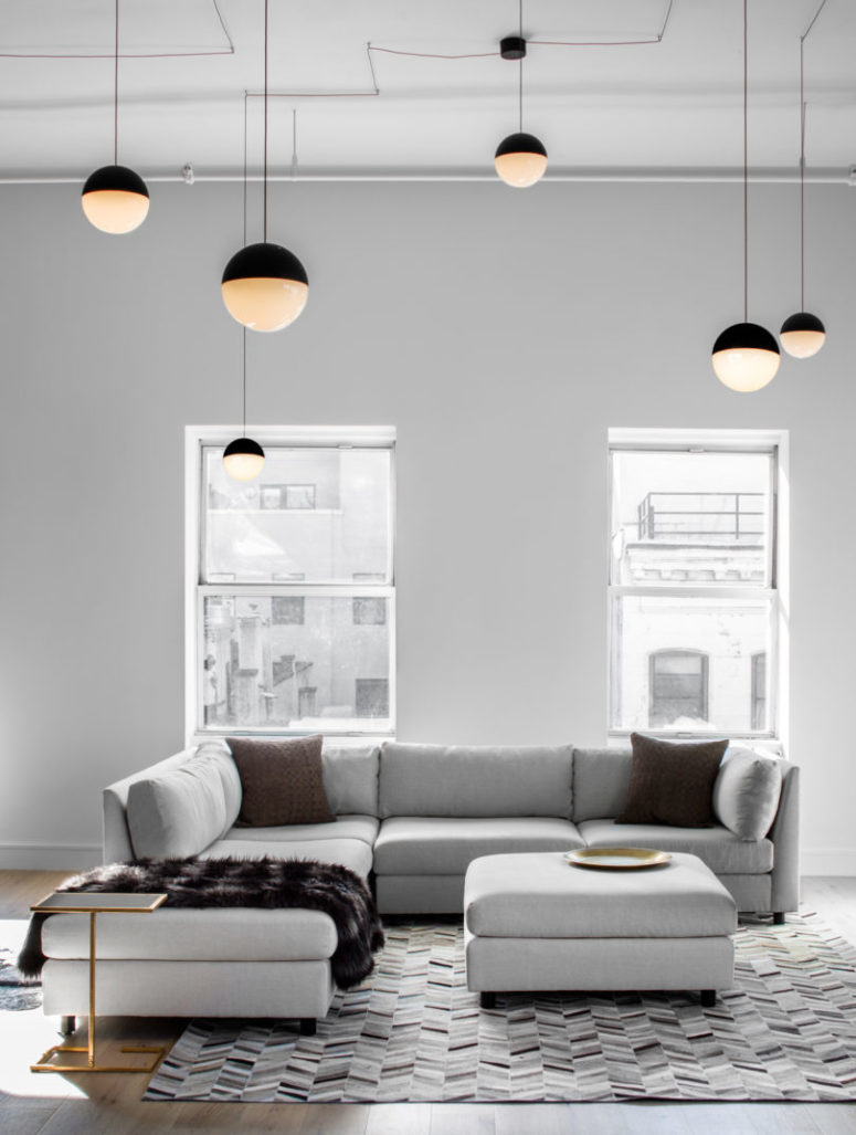 The sitting area features a large light grey sofa with an ottoman and a side table for maximum comfort The sitting area features a large light grey sofa with an ottoman and a side table for maximum comfort