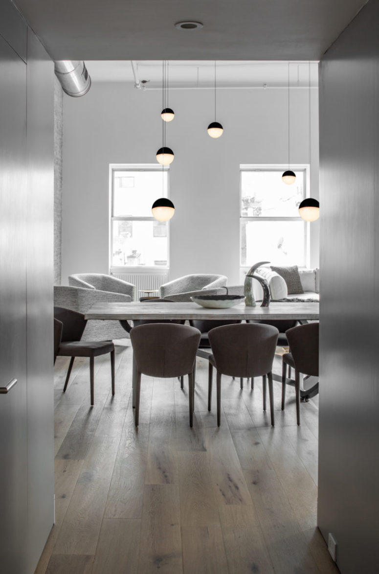 Exposed pipes kept the space industrial and sphere pendant lamps all over the space made it perfectly united Exposed pipes kept the space industrial and sphere pendant lamps all over the space made it perfectly united