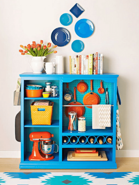 a kitchen island with a pegboard inside for storing various stuff