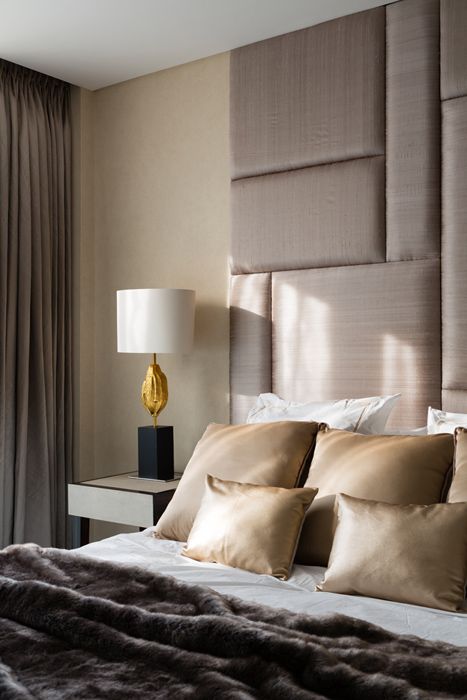 darker taupe shade on the upholstered oversized headboard and curtains for a refined look