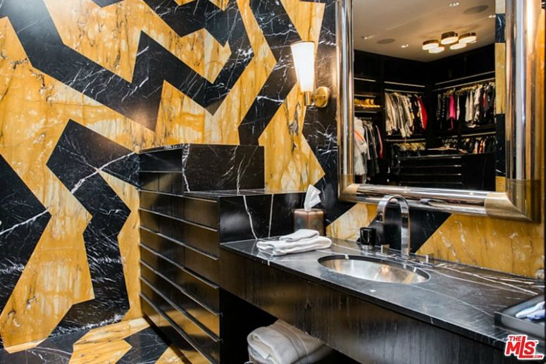 This futuristic bathroom is great with its yellow and black design and a marble tabletop