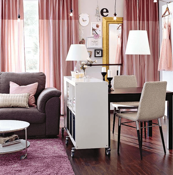 a console on casters separates the spaces and can be moved somewhere else if needed