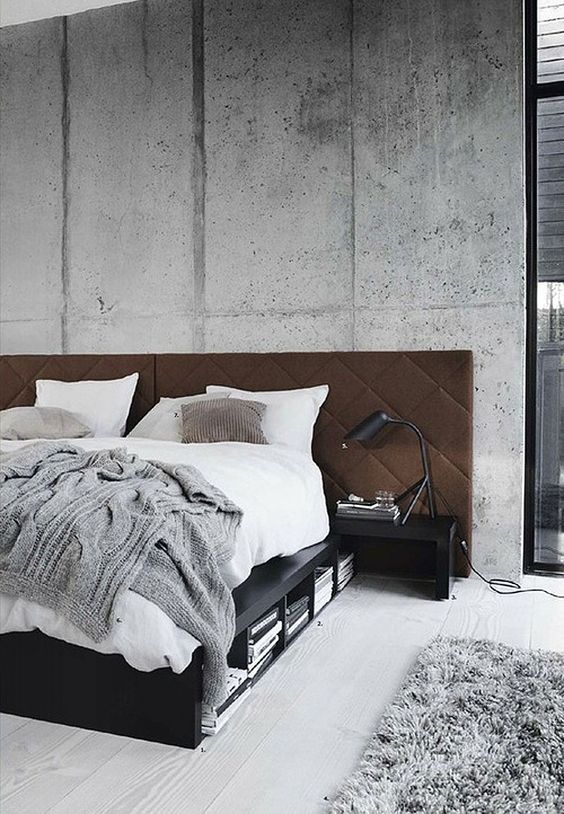this concrete wall echoes with the rug and a knit blanket