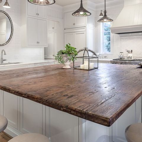 white base kitchen island with a reclaimed wood top looks awesome