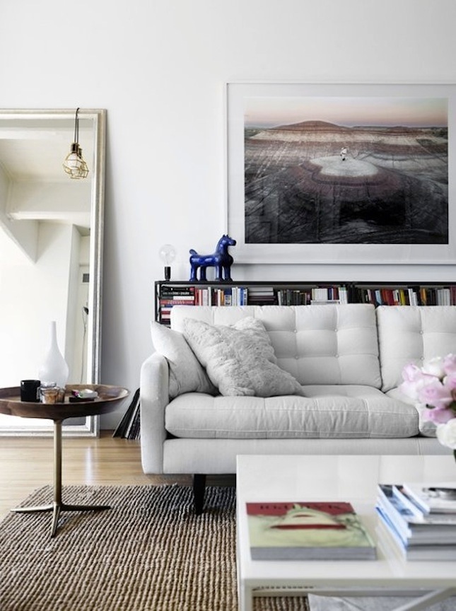 striped rug, pillows and upholstery definitely create a mood here