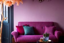 14 mid-century styled sofa in fuchsia color and a light pink wall look harmonious together