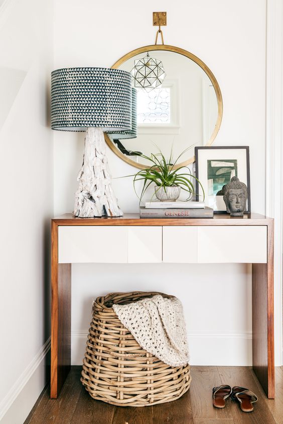 small modern entryway console with a wwooden surface and white drawers