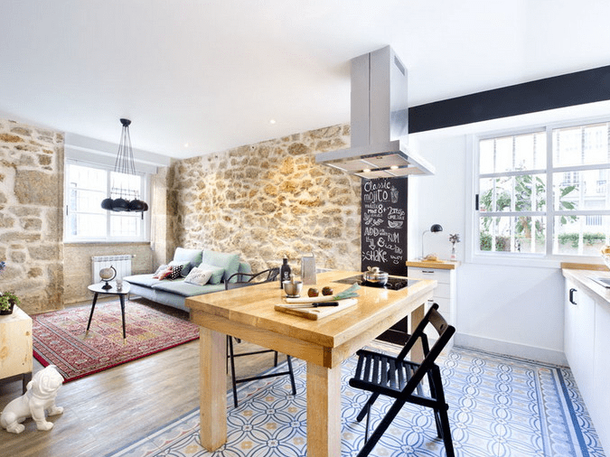 mosaic floor tiles in blue and warm wood floors in the living zone