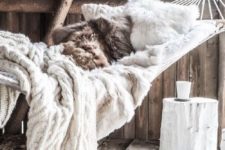 16 hammock with fur pillows and a cable knit blanket