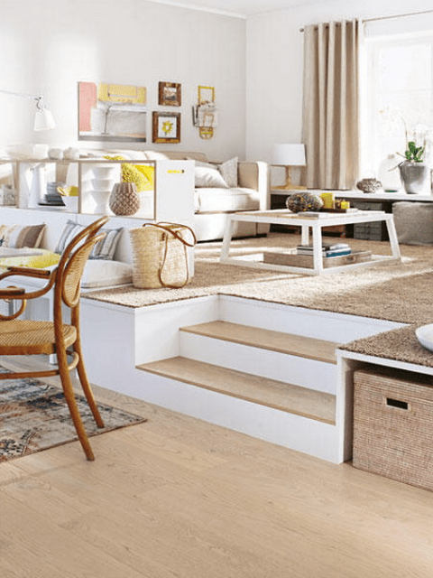 a podium level for a living room and a dining space lower