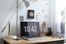 20 white pegboard with hooks for storage over the desk