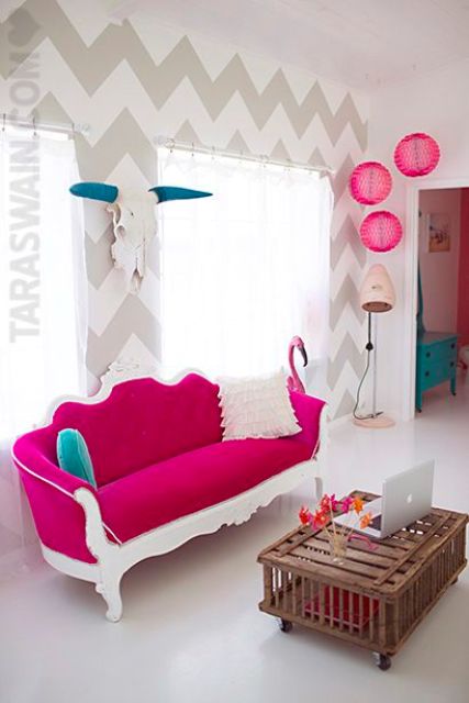 this unusual living space is accentuated with a fuchsia sofa