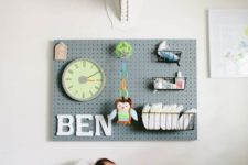 25 a pegboard in a nursery over the diaper changing station is a very practical solution