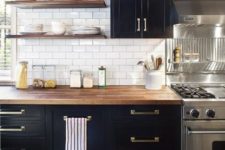 28 elegant black and brass kitchen cabinets and a butcher block countertop