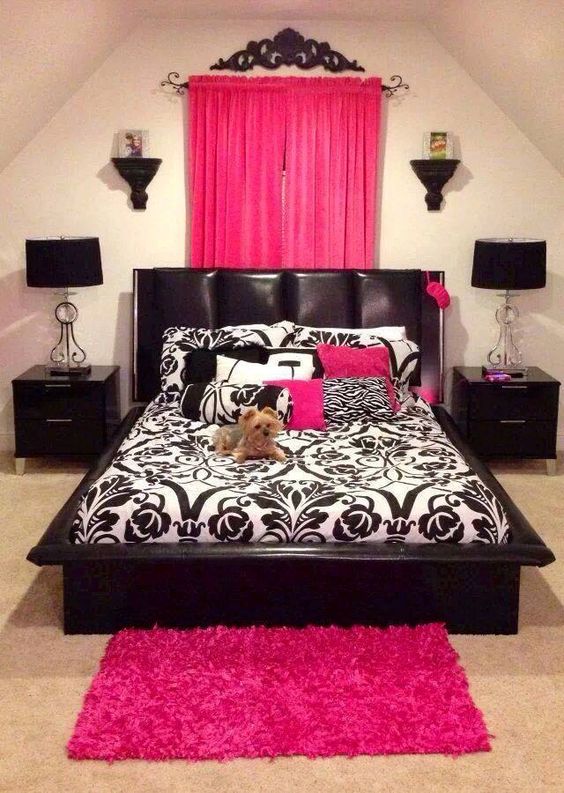 a fuchsia rug and a curtain headboard enliven the black and white space