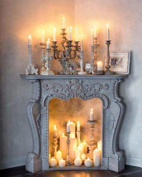 refined fireplace with lots of candles inside and on it