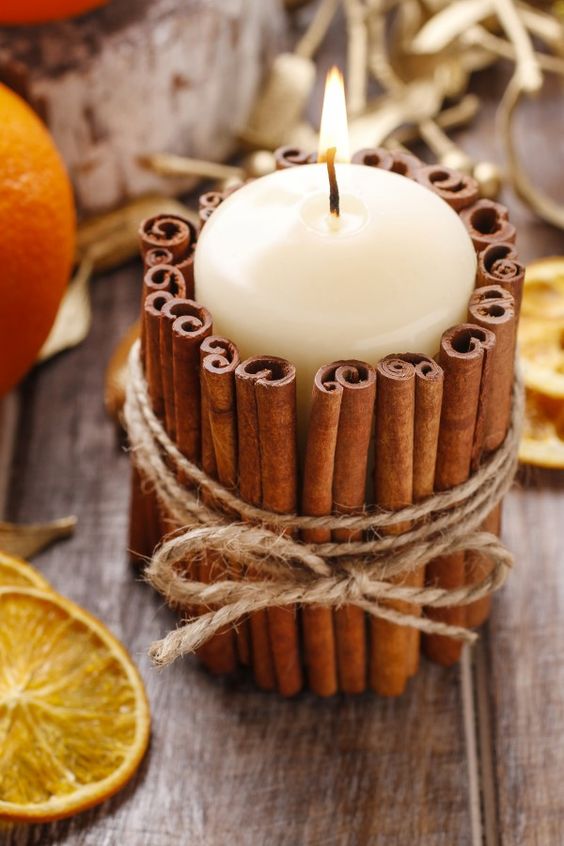 37 candle decorated with cinnamon sticks