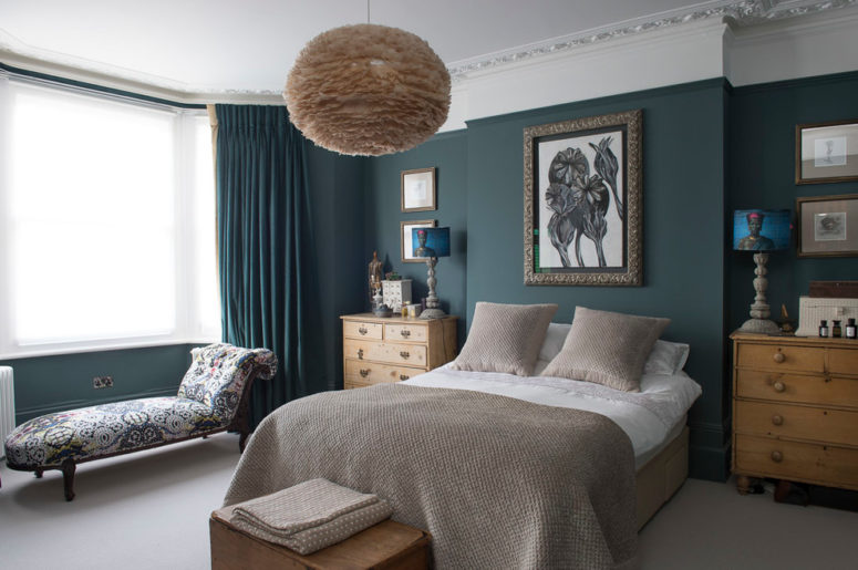 Grayish taupe tones mix well with teal curtains and walls. A fluffy pendant light makes the whole bedroom looks more cozy. (Nicola Hicks Designs)
