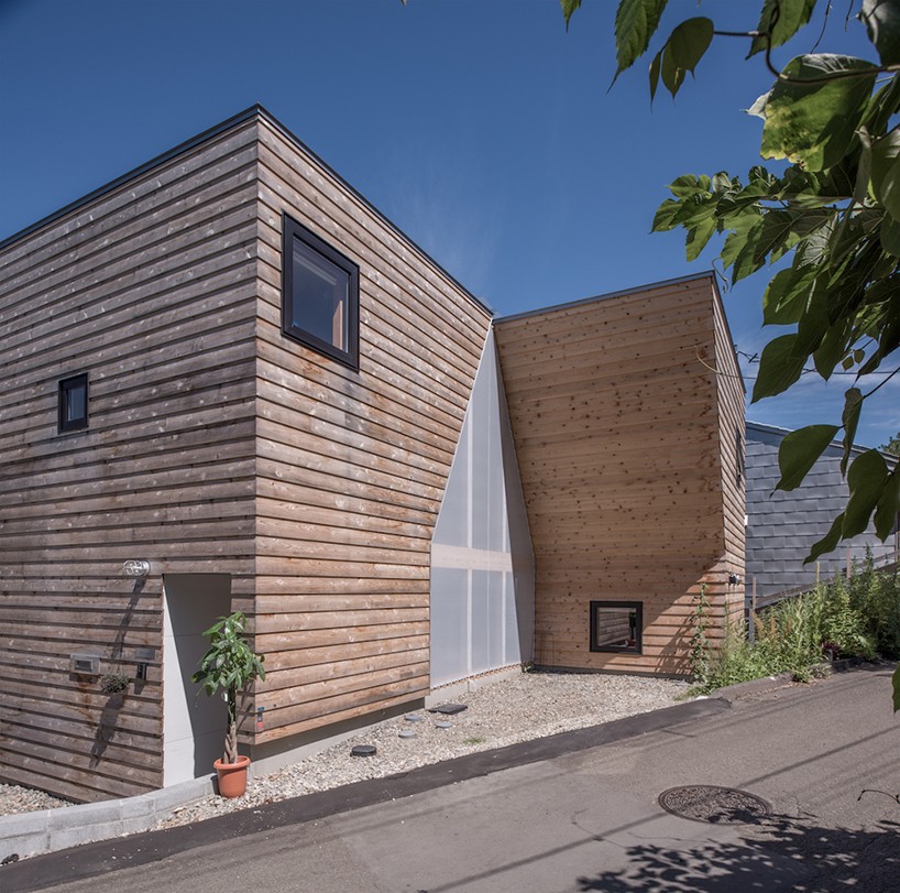 This Japanese residence has a creative facade with a house cutout right in it