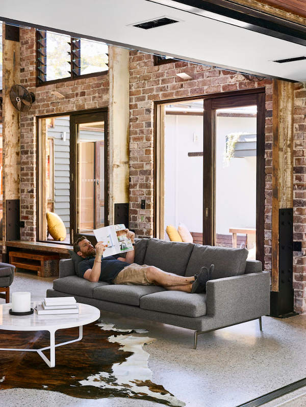 The living space features brick walls, wooden rustic beams that support the ceiling and a cool animal skin rug, the furniture itself is rather neutral The living space features brick walls, wooden rustic beams that support the ceiling and a cool animal skin rug, the furniture itself is rather neutral